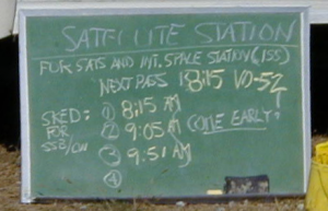 The chalkboard outside the Satellite Station lists upcoming passes.